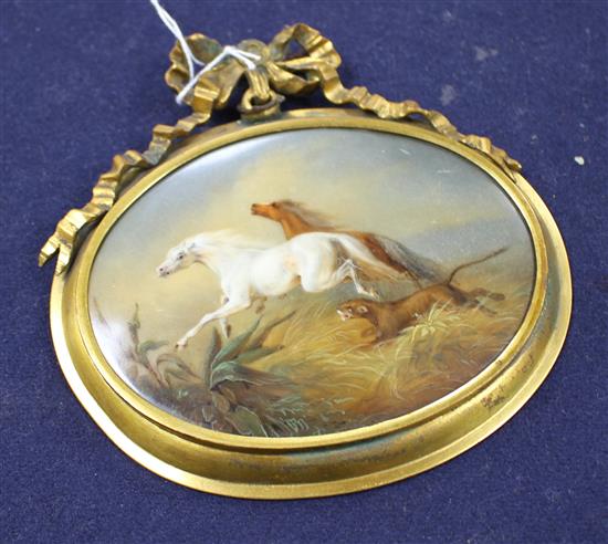 A 19th century oval porcelain plaque depicting horses fleeing from a lion, in gilt frame with ribbon surmount